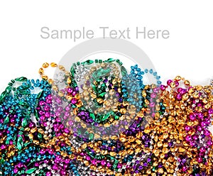 Mardi gras beads on white with copy space