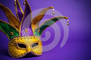 Mardi Gras or Carnivale mask on purple