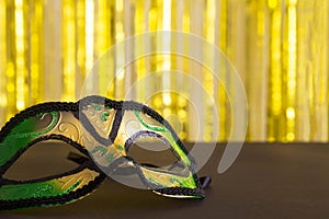 Mardi gras mask close up on the gold backgtound photo
