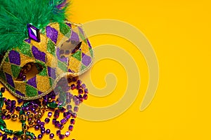 Mardi Gras or venetian mask on yellow photo