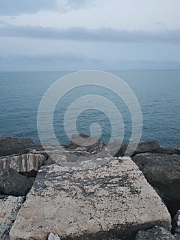 Clowdy sea rocks photo