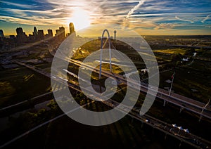 Margaret Hunt Hill Bridge Sunrise Dallas Texas Skyline Downtown Cityscape Sunrise sun rays over Urban Prawl massive City