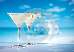 Margarita cocktail on beach, blue sea and sky background photo