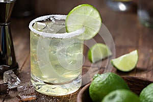 Margarita cocktail with ice, lime and salt riim