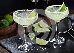 Margarita cocktail with ice, lime and salt rim