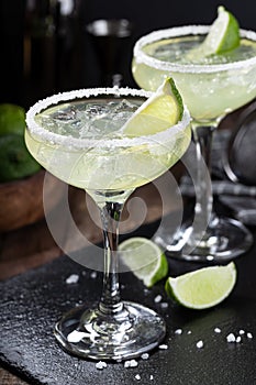 Margarita cocktail with ice, lime and salt rim