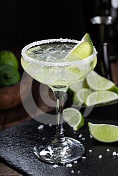 Margarita cocktail with ice, lime and salt rimm