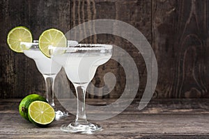 Margarita cocktails on a rustic wooden table photo