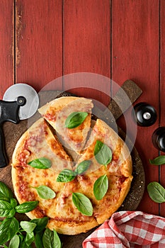 Margarita pizza. Traditional neapolitan margarita pizza and cooking ingredients tomatoes basil on wooden table backgrounds