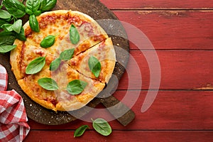 Margarita pizza. Traditional neapolitan margarita pizza and cooking ingredients tomatoes basil on wooden table backgrounds