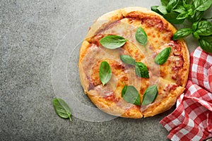 Margarita pizza. Traditional neapolitan margarita pizza and cooking ingredients tomatoes basil on wooden table backgrounds