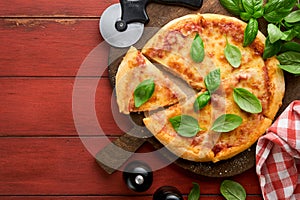 Margarita pizza. Traditional neapolitan margarita pizza and cooking ingredients tomatoes basil on wooden table backgrounds