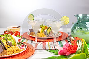 Margaritas with salt and limes and mexican food photo
