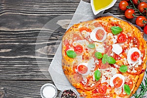 Margherita Italian pizza with melted mozzarella cheese, tomato and fresh basil