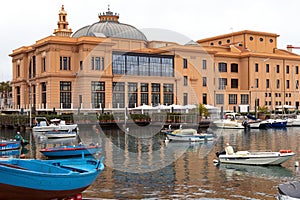 Margherita Theater and fishing boats in old harbor of Bari, Puglia, Italy