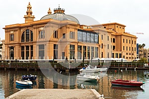 Margherita Theater and fishing boats in old harbor of Bari, Puglia, Italy