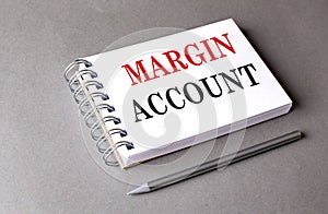 MARGIN ACCOUNT text on notebook on grey background