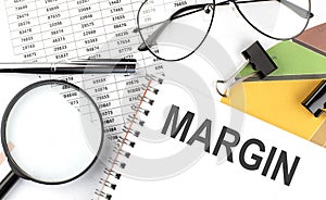 MARGIN - the inscription of text on the Notepad, and chart. Business concept