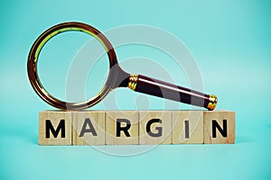 Margin with wooden blocks alphabet letters and Magnifying glass on blue background