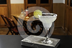 Marguerita cocktail is on the bar. Space for text. Photo for the menu