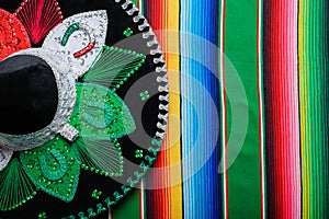 Mariachi hat with the colors of the Mexican flag on a colorful serape