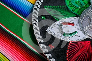 Mariachi hat with the colors of the Mexican flag on a colorful serape