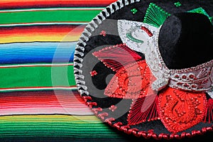 Mariachi hat with the colors of the Mexican flag on a colorful serape