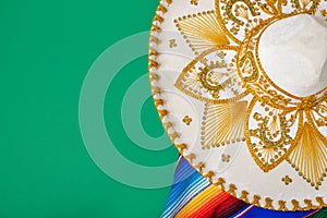 Mariachi hat and serape on green background. Cinco de mayo background