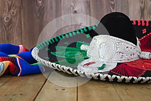 Mariachi hat and serape on wooden table. Mexican independence concept.