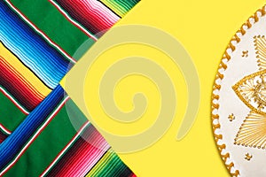 Mariachi hat and serape on yellow background. Cinco de mayo background