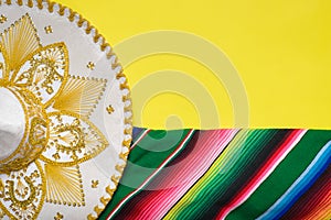 Mariachi hat and serape on yellow background. Cinco de mayo background