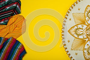 Mariachi hat and serape on yellow background. Mexican concept. Cinco de mayo background