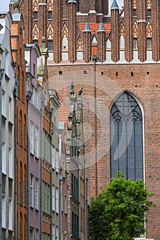 Mariacka street with colorful facades of tenement houses and St.Mary Church, Gdansk, Poland