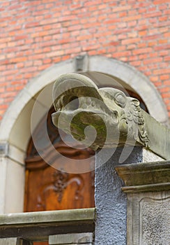 Mariacka street, grotesque gargoyle on front of tenement house, Gdansk, Poland