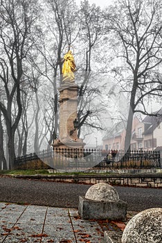 Marian column Immaculata in foggy park in city Ruzomberok, Slovakia