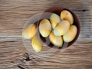 Marian plum in wooden bowl