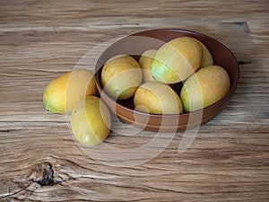 Marian plum in wooden bowl