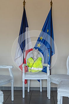 Marianne symbol of the French Republic with a yellow vest gilet jaune during the great national debate of the citizen consultati