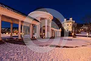 Marianske Lazne Marienbad - small spa town in winter under snow - white columns colonnade Kolonada in Czech and church