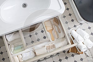 Marie Kondo's method organization of bathroom amenities. Tidying up or storage household space