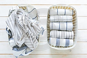 Marie Kondo tidying concept - folded kitchen linens in white basket photo