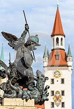 Marienplatz Square detail, Munich, Germany. Statue of angel closeup on background of Altes Rathaus or Old Town Hall