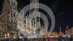 Marienplazt Old Town Square with Town Hall Clock Tower Glockenspiel night timelapse hyperlapse.