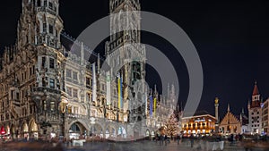 Marienplazt Old Town Square with Town Hall Clock Tower Glockenspiel night timelapse hyperlapse.