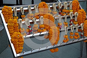 Marigold garlands in front of spirit house