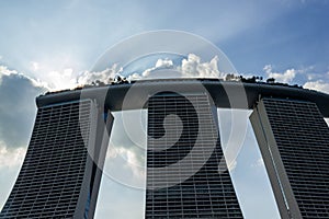 Marina Bay Sands on blue sky background with some clouds and sun rays, SINGAPORE