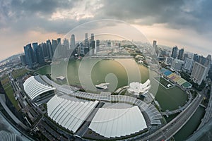 Marina Bay with urban skyscrapers at sunset.