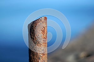 Marina bollard bitt at jetty for boats, ships and yachts mooring. Old broken rusty metal sticks on a pier