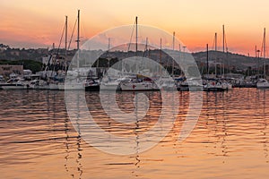 Marina with docked yachts at sunset