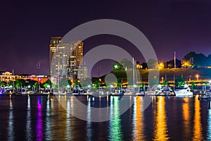 A marina and Federal Hill at night at the Inner Harbor in Baltimore, Maryland.